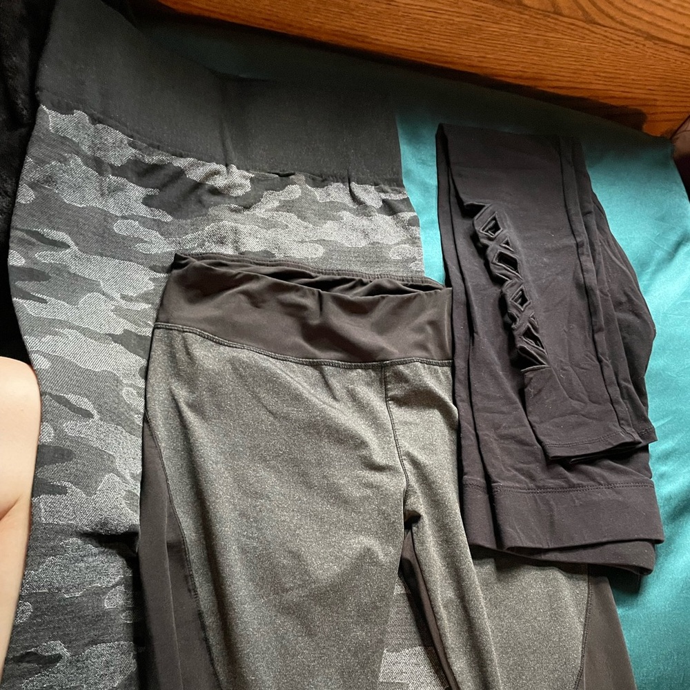 3 pairs of black patterned leggings, one pair has cut outs on calf